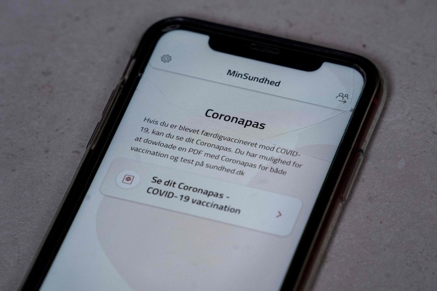 A smartphone displays the Danish app MinSundhed and a link to Coronapas, Copenhagen, Denmark, March 23, 2021. AFP Photo